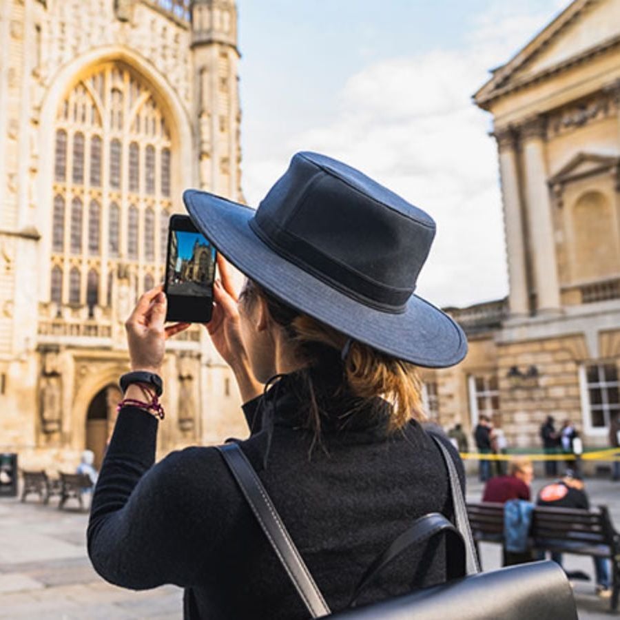 person taking a photo of a church on a phone