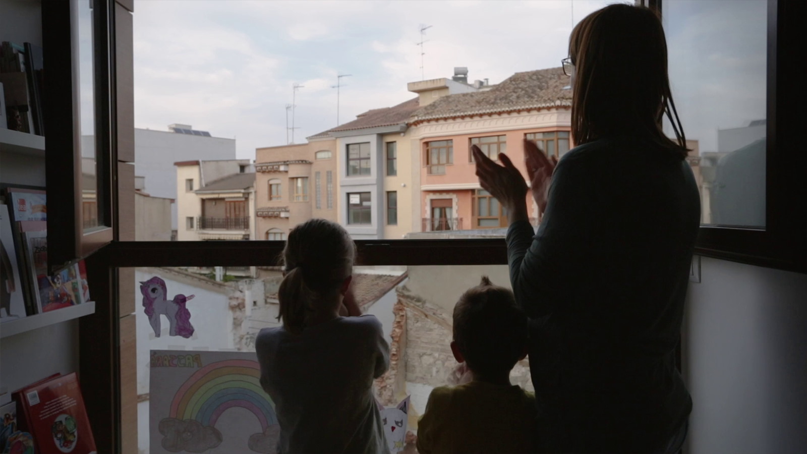 Family clapping at window