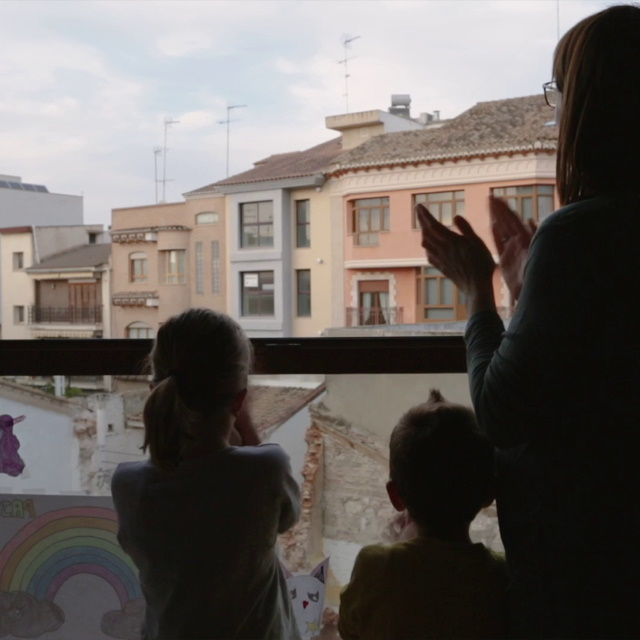 Family clapping at window